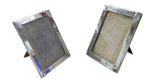 A matched pair of George V silver frames, each of rectangular form with easel backs, Birmingham...