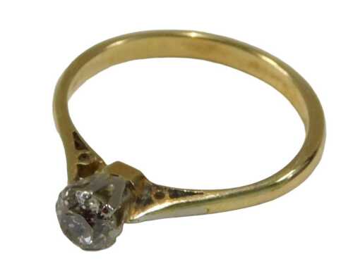 A solitaire ring, set with small white stone, unmarked shank, ring size M.