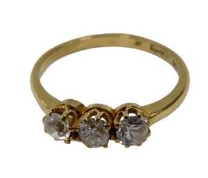 A three-stone diamond dress ring, set with three old cut diamonds, each approximately 0.15ct,...