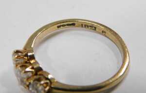 A three-stone diamond dress ring, set with three old cut diamonds, each approximately 0.15ct,... - 2
