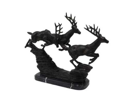 A spelter figure group of running stags, in a naturalistic setting on marble base, 36cm high.