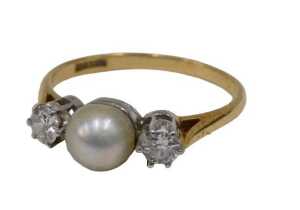 A pearl and diamond three-stone dress ring, with single cultured pearl to centre flanked by two...