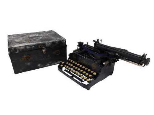 An early 20thC Perkeo miniature typewriter, in black with gilt highlights, 23cm wide, cased.