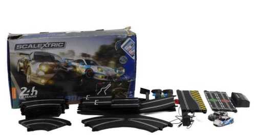 A Scalextric 24 Le Mans Porsche 911 RSR racing car set, partially boxed, 78cm wide.