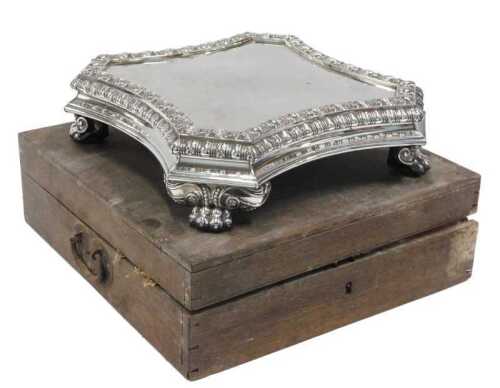 A 19thC silver plated wedding cake stand, of inverted square form, with raised shell border, on...