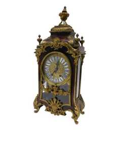 A 19thC French Boulle mantel clock, the raised enamel 15cm diameter Roman numeric dial in highly elaborate case, with caddy top surmounted by single urn and four further urn finials, the glazed front raised with urns, flowers and scrolls, on scroll feet, 
