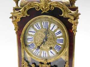 A 19thC French Boulle mantel clock, the raised enamel 15cm diameter Roman numeric dial in highly elaborate case, with caddy top surmounted by single urn and four further urn finials, the glazed front raised with urns, flowers and scrolls, on scroll feet, - 4