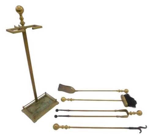 An early 20thC brass fireside companion set, on stand, to include shovel, 70cm high.