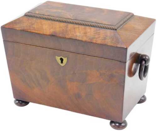 An early 19thC flame mahogany sarcophagus shaped tea caddy, of small proportion, rectangular lid...