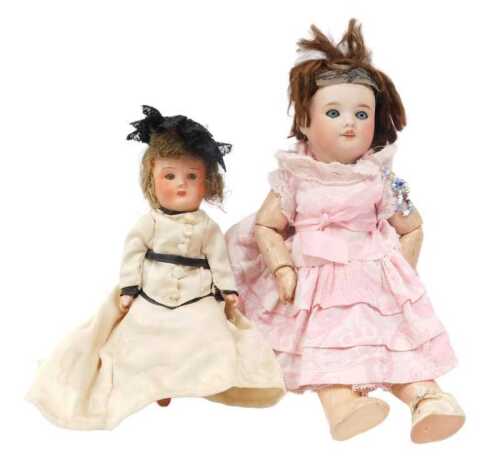 An early 20thC bisque headed doll, with articulated limbs and flowing dress, 21cm high, and a...