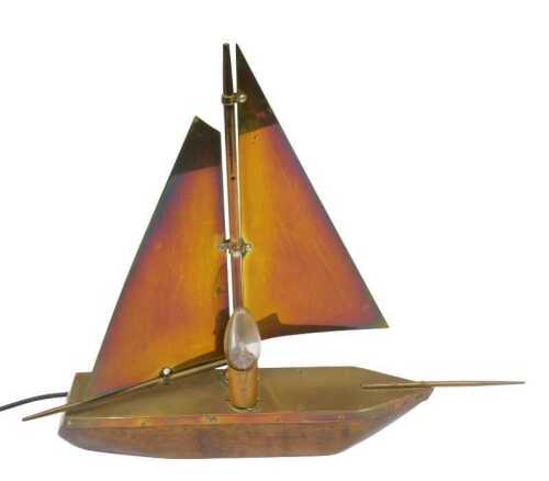 An oak and brass 1950s sail boat table lamp, with articulated sails, 45cm high. WARNING! This...