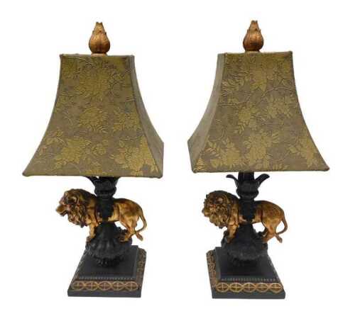 A pair of table lamps, with elaborate shades, raised with flowers, above lion and vase stems, on...