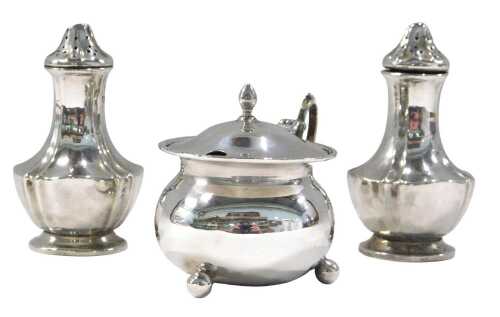 A Harlequin silver cruet set, comprising two pepper pots, 18cm high, and a mustard pot, Chester...