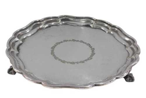 A 19thC salver, pie crust edge, central floral scroll engraving, and ball and claw feet,...
