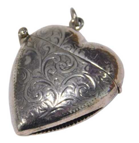 An early 20thC heart shaped Vesta case, profusely decorated with scrolls, marked sterling 925,...