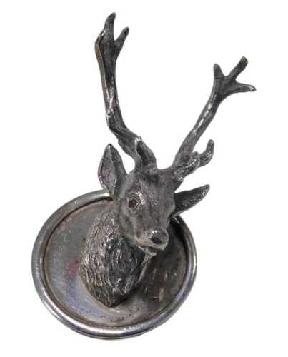 A 20thC silver raised stag head, possibly a menu holder, the eyes picked out in red, London...