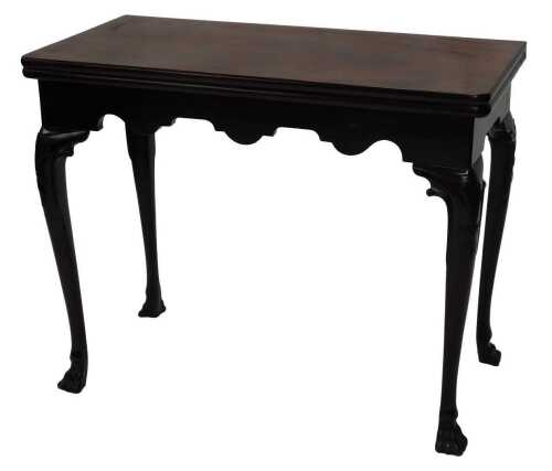 A George II mahogany card table, the rectangular foldover top baize lined, above a shaped apron...