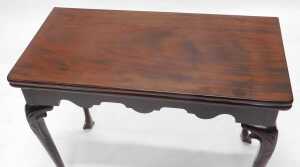 A George II mahogany card table, the rectangular foldover top baize lined, above a shaped apron... - 2