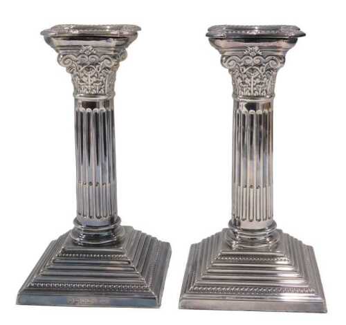A pair of Elizabeth II sterling silver candlesticks, by Carr's of Sheffield, each of Corinthian...