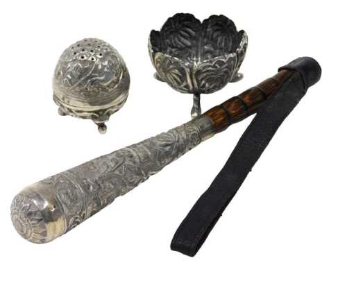 An early 20thC Indian parasol handle, with turned bamboo and whip end, raised white metal handle...