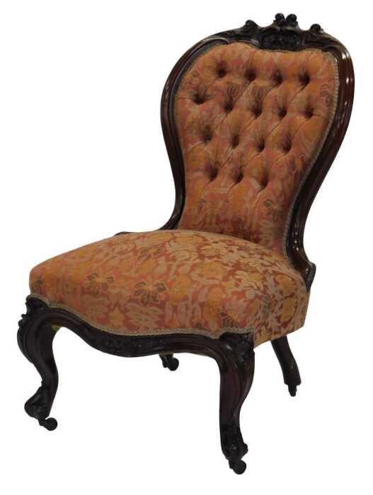 A Victorian rosewood show frame nursing chair, with a buttoned padded back and a padded seat...