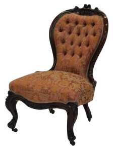 A Victorian rosewood show frame nursing chair, with a buttoned padded back and a padded seat...