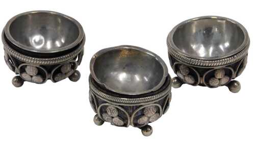 Three early 20thC open salts, with pierced clover leaf borders, on orb feet, with removable...