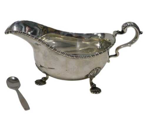 An Elizabeth II silver sauceboat, by Edward Barnard & Sons Limited, of cape form, with leaf...