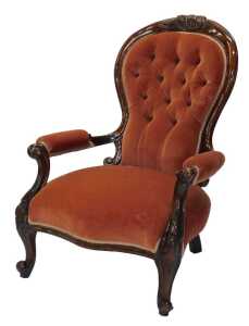 A Victorian walnut show frame open armchair, with a buttoned padded back, padded armrest and...