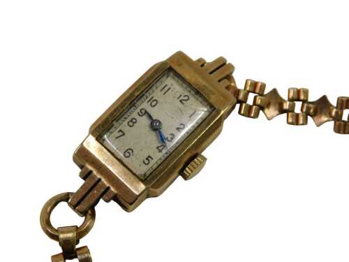 A 9ct gold cased ladies wristwatch, with silvered numeric watch head and blue hands, on a...