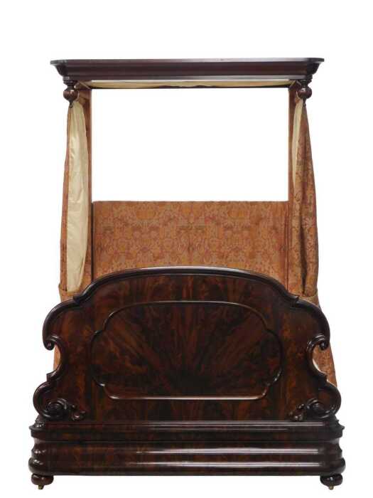 A Victorian figured mahogany half tester bed, the moulded canopy with drop finials, the shaped...