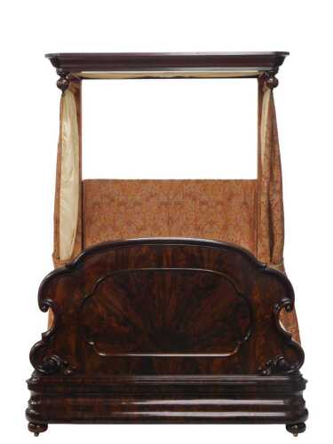 A Victorian figured mahogany half tester bed, the moulded canopy with drop finials, the shaped...