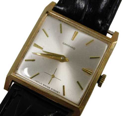 A Garrard 9ct gold cased gent's wristwatch, the silvered square watch head with reverse...
