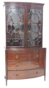A George III mahogany glazed bowfronted cabinet, the top with a moulded cornice above two...