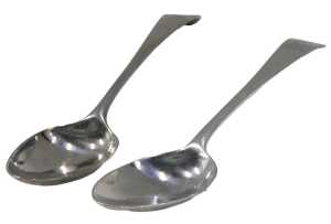 A matched pair of George III silver fiddle pattern serving spoons, each bearing crest with a...