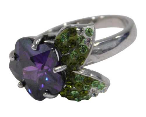 A silver dress ring, set as a purple flower with paste stone set green and white leaves, ring...