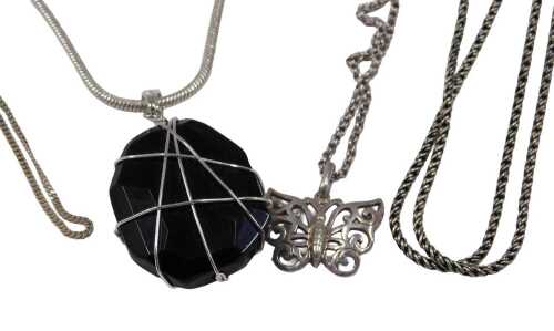 A group of silver jewellery, comprising a butterfly pendant and chain, a fine link neck chain, a...