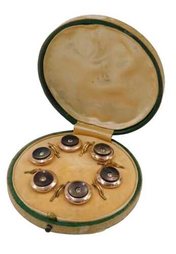 A 1970s gentlemen's collar stud set, each set with mother-of-pearl and central paste stone, in a...