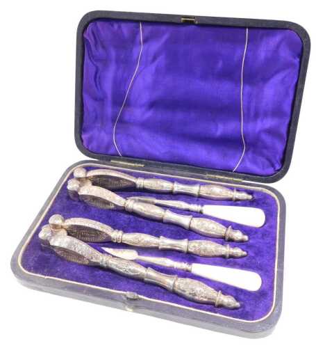 An early 20thC silver plated nutcracker and pick set, in fitted case, 17cm wide.