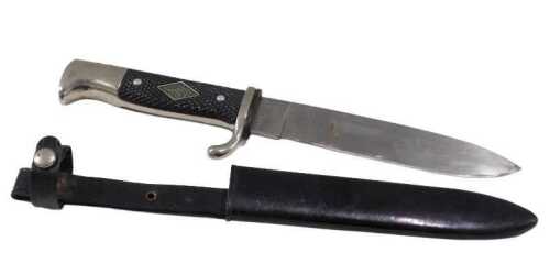 A 20thC Solingen German dagger, with shaped blade and handle, set with fleur de lys, with metal...