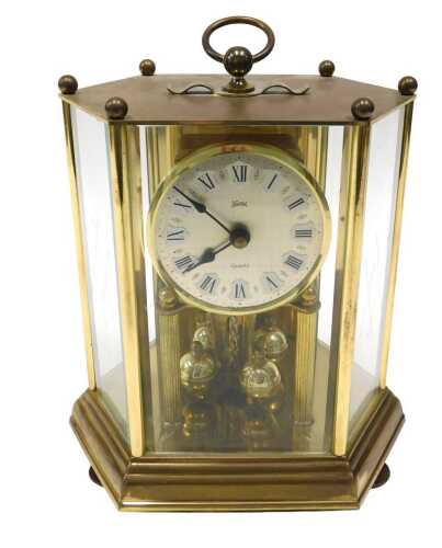 A Koma quartz anniversary clock, with 9cm diameter Roman numeric dial housed in an octagonal...