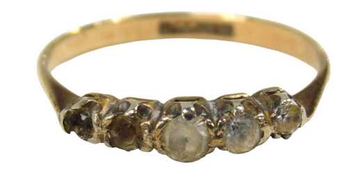A five stone dress ring, set with four imitation diamonds, one missing, in a rub over platinum...