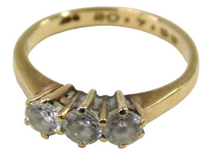 A 9ct gold three stone dress ring, set with three imitation diamonds, each in a raised claw...