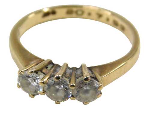 A 9ct gold three stone dress ring, set with three imitation diamonds, each in a raised claw...