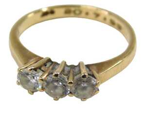 A 9ct gold three stone dress ring, set with three imitation diamonds, each in a raised claw...