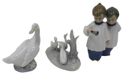Various Nao figures, goose, another figure group, and two choir boys ringing bell, 19cm high. (3)