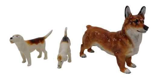 A Royal Doulton dog figure Corgi, 13cm high, printed marks beneath, and two Beswick hounds. (3)