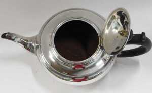 A George V silver teapot, by the Harrison Brothers, of circular form, with ebonised thumb mould... - 2