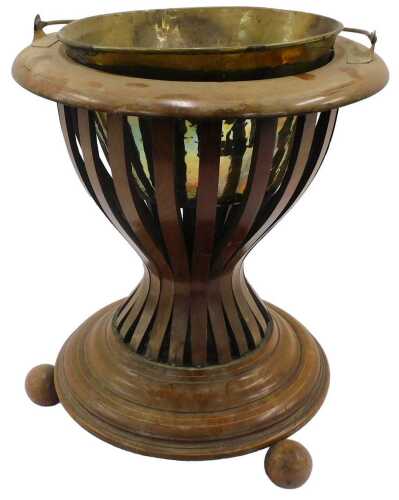A 19thC mahogany jardiniere, with removable brass section, swing handle, inverted pierced stem,...
