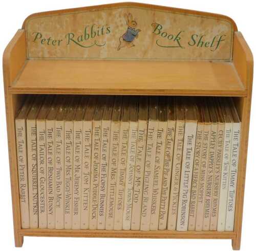 Potter (Beatrix). Peter Rabbit bookshelf, 25 editions including Peter Rabbit in beech shelving.
